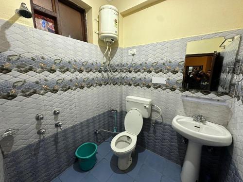 Aerial view of McLeod Ganj village cluster surrounded by pine forest and mountains